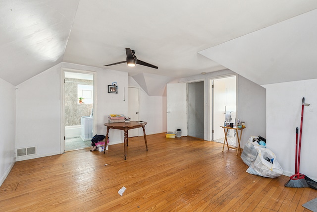 additional living space with ceiling fan, light wood-type flooring, and vaulted ceiling