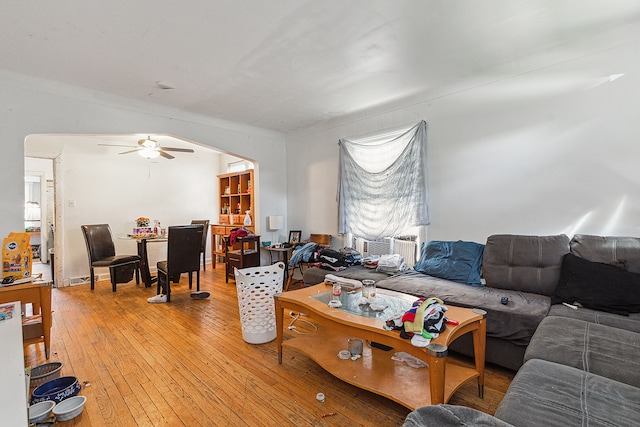 living room with wood-type flooring and ceiling fan