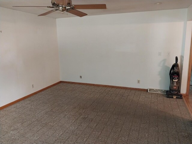 empty room with baseboards, wood finished floors, and ceiling fan