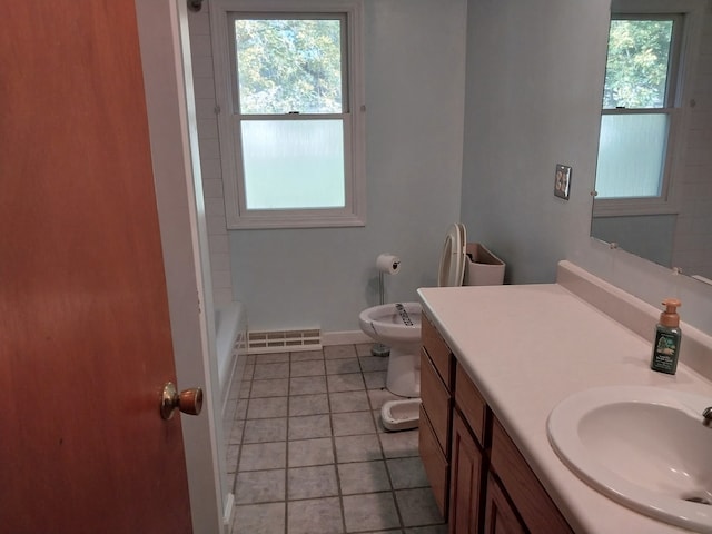 full bathroom with vanity, tile patterned flooring, a healthy amount of sunlight, and toilet