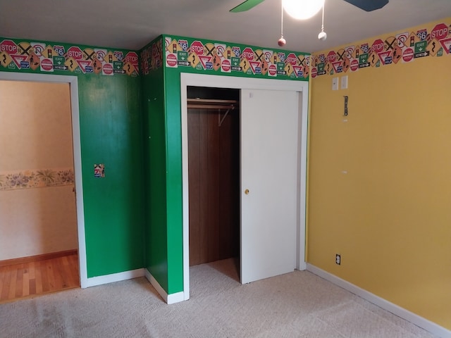 unfurnished bedroom with a closet, ceiling fan, and carpet flooring