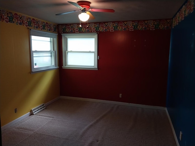 empty room with carpet flooring, visible vents, baseboards, and ceiling fan