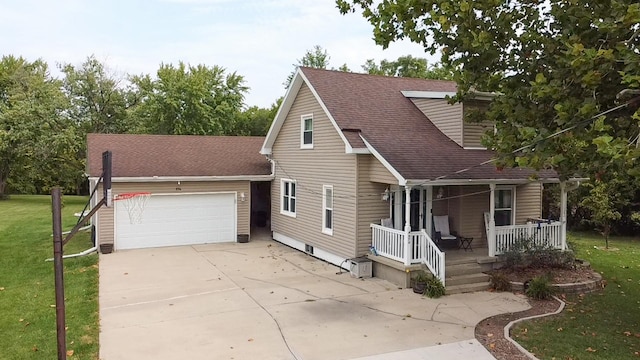 view of front facade featuring a garage, a porch, and a front lawn