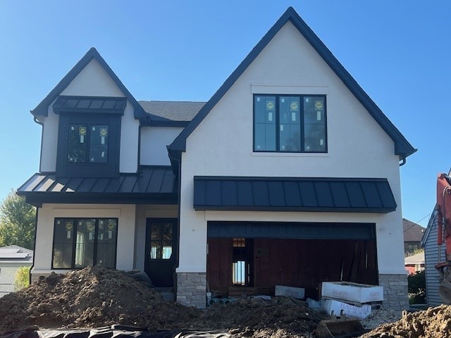 rear view of property featuring a garage