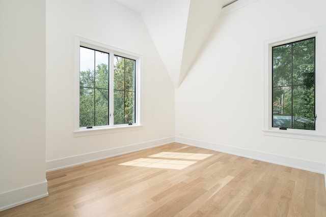 bonus room with light hardwood / wood-style floors and lofted ceiling