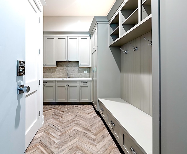 mudroom featuring light parquet floors and sink