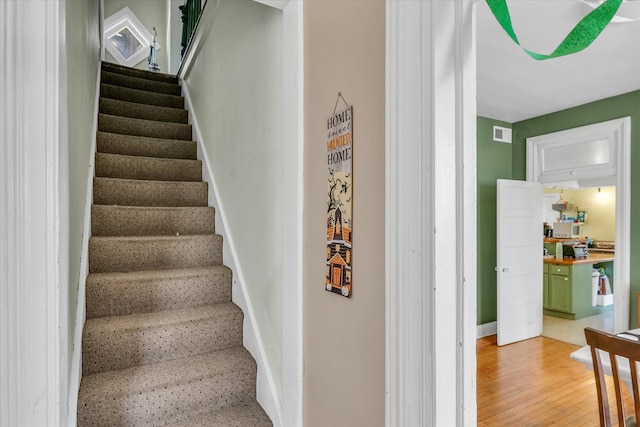 stairs with hardwood / wood-style floors