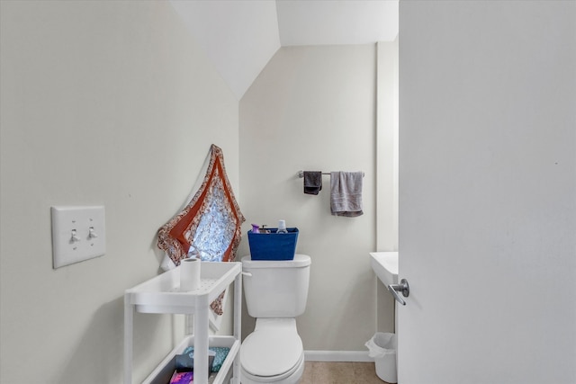 bathroom featuring tile patterned floors, vaulted ceiling, and toilet