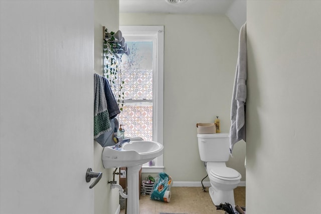 bathroom featuring toilet and tile patterned flooring