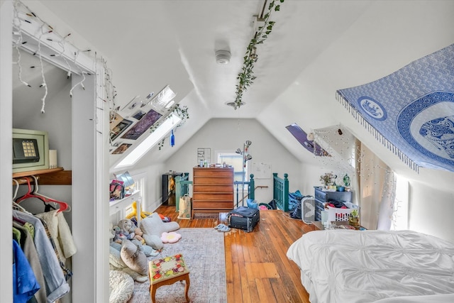 bedroom featuring lofted ceiling and hardwood / wood-style flooring