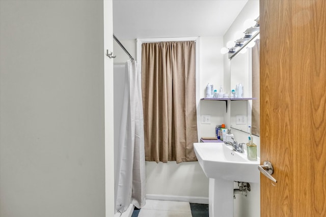 bathroom featuring walk in shower and tile patterned flooring