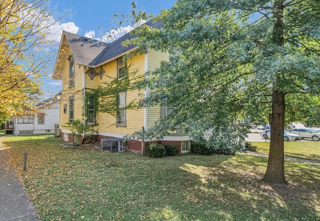 view of property exterior featuring a yard and central air condition unit