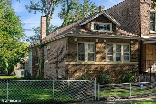 view of side of property with a yard