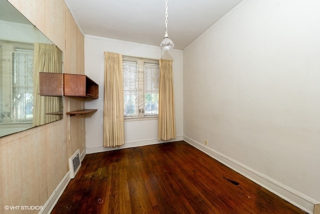 unfurnished dining area with ornamental molding and dark wood-type flooring