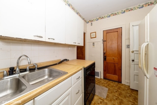 kitchen featuring sink, tasteful backsplash, white cabinetry, dishwasher, and white fridge with ice dispenser