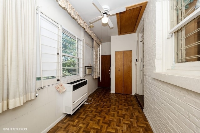 hall with brick wall, dark parquet floors, and radiator heating unit