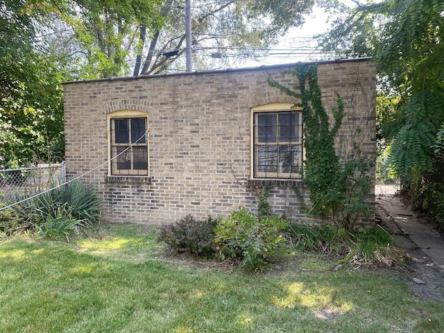 view of home's exterior with a lawn