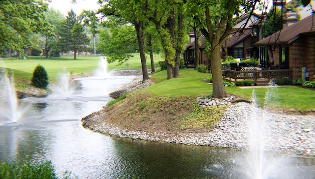 view of community with a yard and a water view