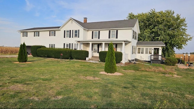 17580 1200 E St, Wyanet, IL 61379 - view of front of home with a chimney, covered porch, and a front lawn