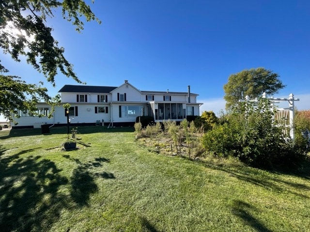 rear view of property with a yard