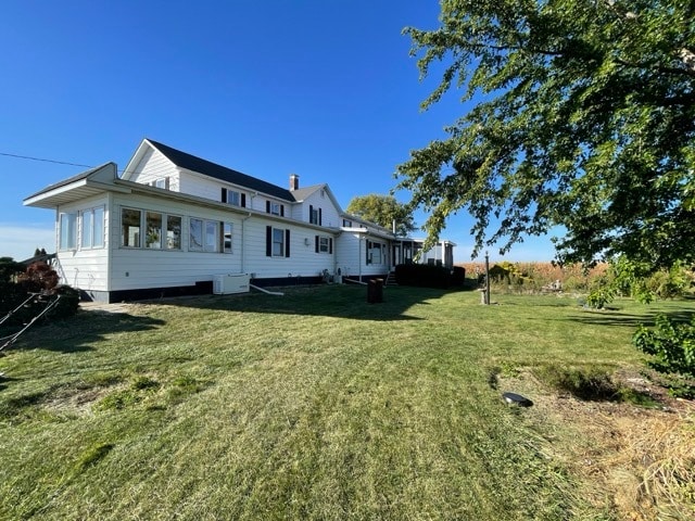 back of property featuring a yard