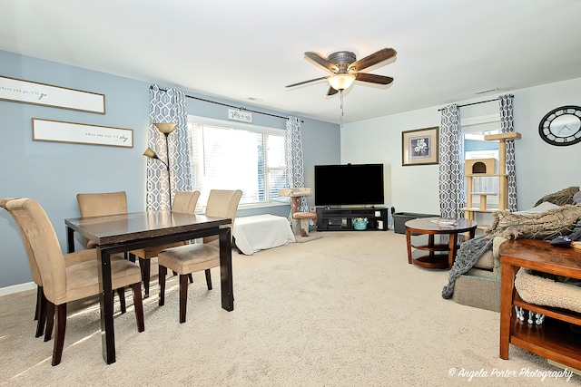 dining room featuring ceiling fan and light carpet