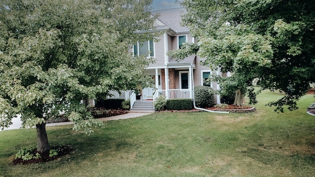 view of front of property with a porch and a front yard