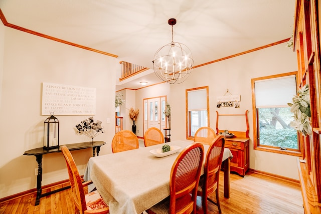 dining room with light hardwood / wood-style flooring, a notable chandelier, a wealth of natural light, and crown molding