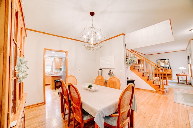 dining space with baseboards, light wood-style flooring, stairs, crown molding, and a chandelier