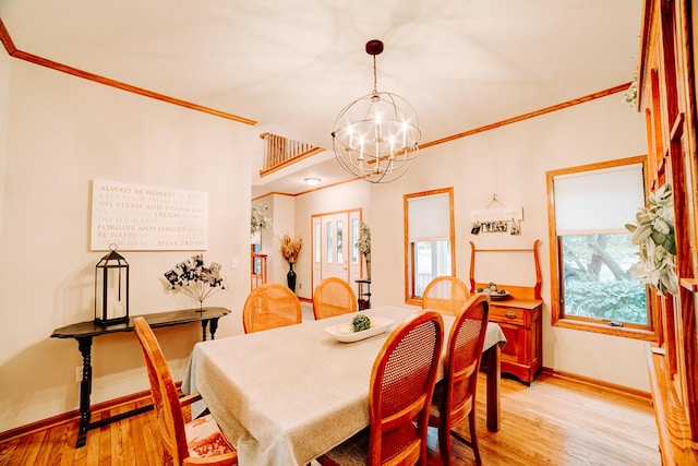 dining room with an inviting chandelier, baseboards, light wood finished floors, and ornamental molding