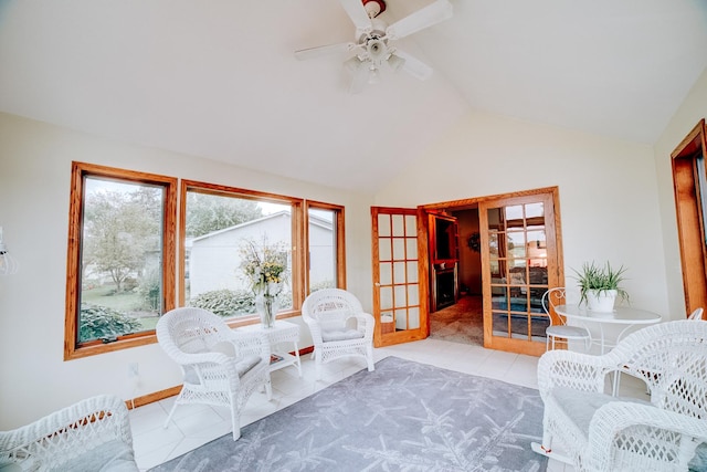 living area featuring tile patterned flooring, lofted ceiling, french doors, and ceiling fan