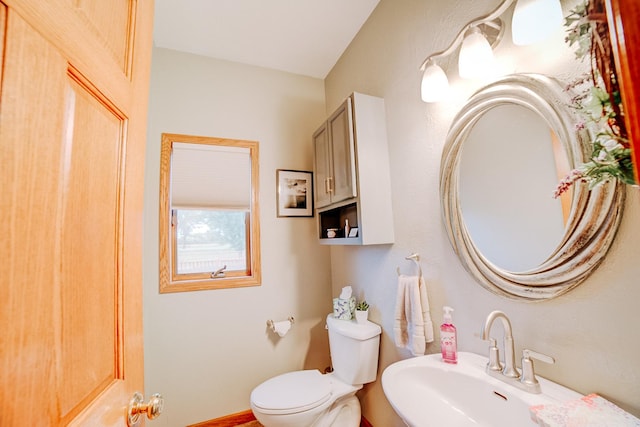 bathroom with toilet and a sink