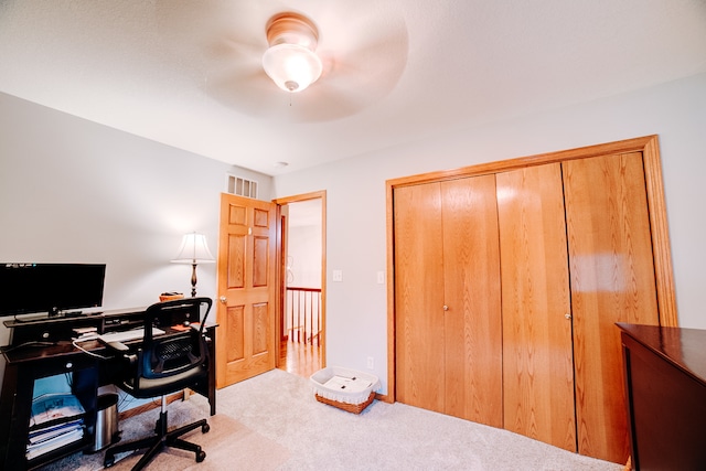 carpeted office with ceiling fan