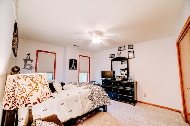 carpeted bedroom featuring a closet and ceiling fan