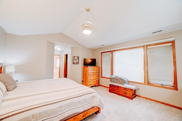 carpeted bedroom featuring visible vents, baseboards, and vaulted ceiling