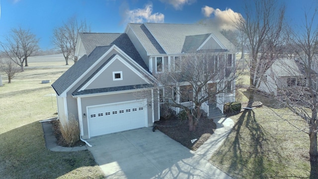 view of front facade with a front yard, concrete driveway, a garage, and roof with shingles