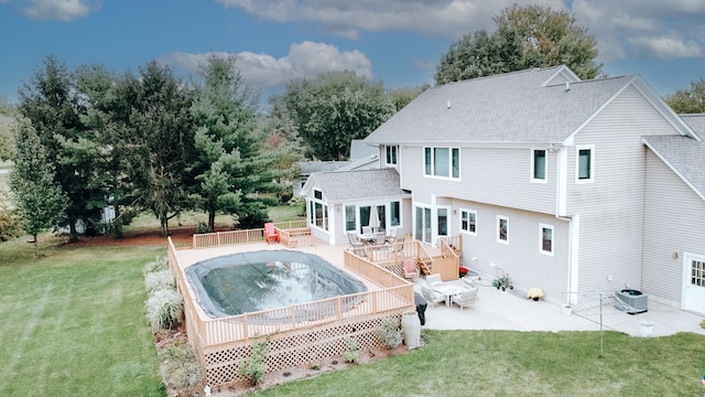 rear view of property featuring a patio, central AC, a deck, and a lawn