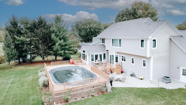 back of house with a yard, central AC unit, a deck, and roof with shingles