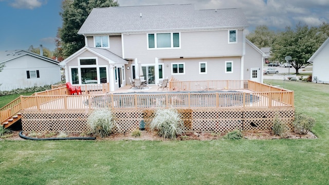 back of property featuring a deck, outdoor dining space, a shingled roof, and a yard