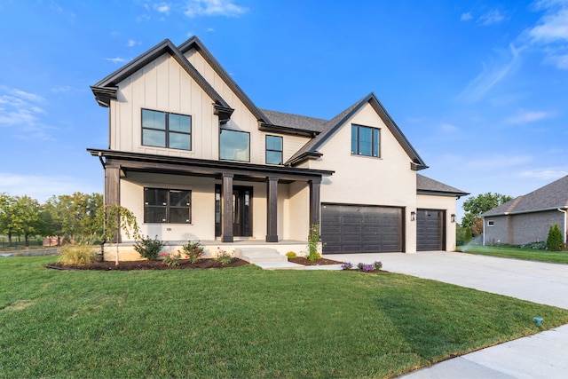 view of front of home featuring a front lawn, a garage, and a porch