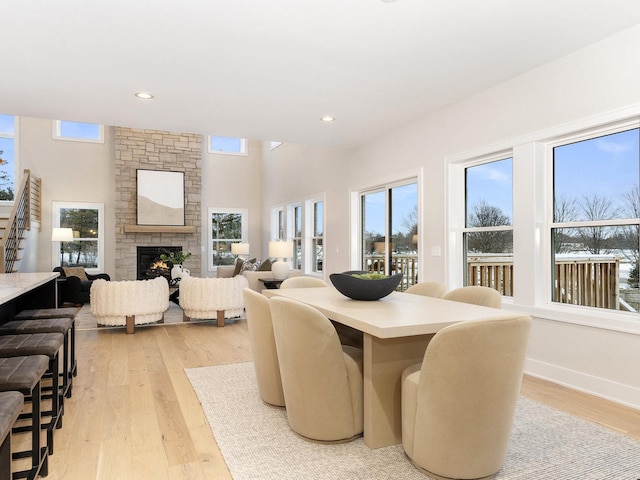 dining room with light hardwood / wood-style floors and a fireplace