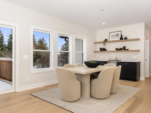 dining space with light hardwood / wood-style floors