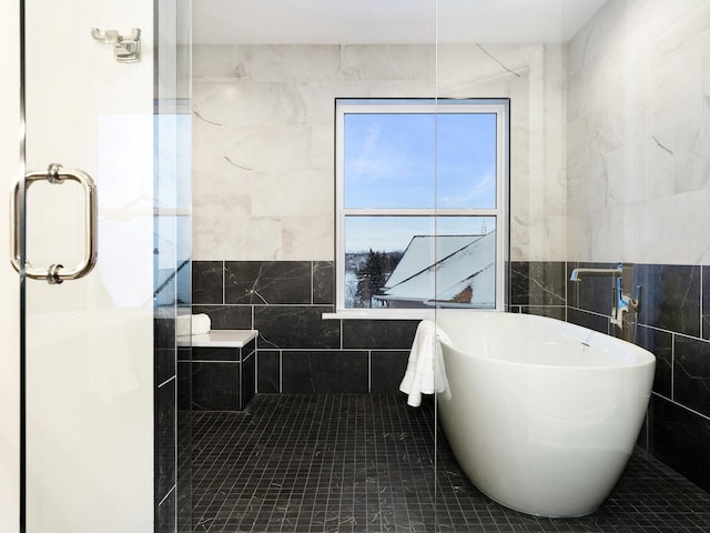 bathroom with tile walls and plus walk in shower