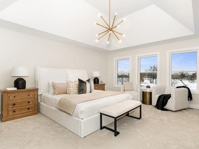 carpeted bedroom with multiple windows, a raised ceiling, and a notable chandelier