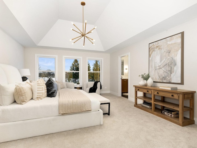 bedroom with light carpet, an inviting chandelier, a tray ceiling, and ensuite bath