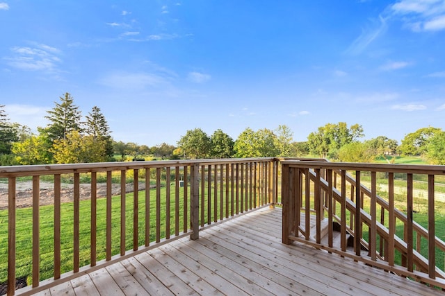 wooden deck with a lawn