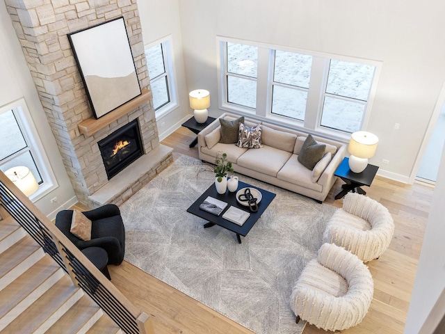 living room featuring hardwood / wood-style floors and a stone fireplace