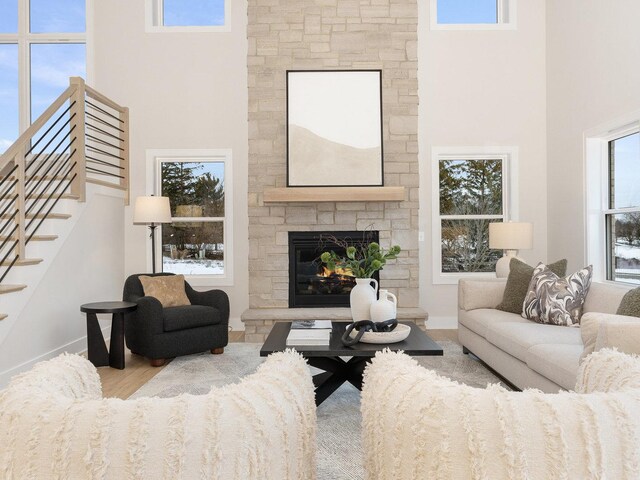 1519 77th St, Naperville, IL 60565 - living area featuring a stone fireplace, a high ceiling, and stairway