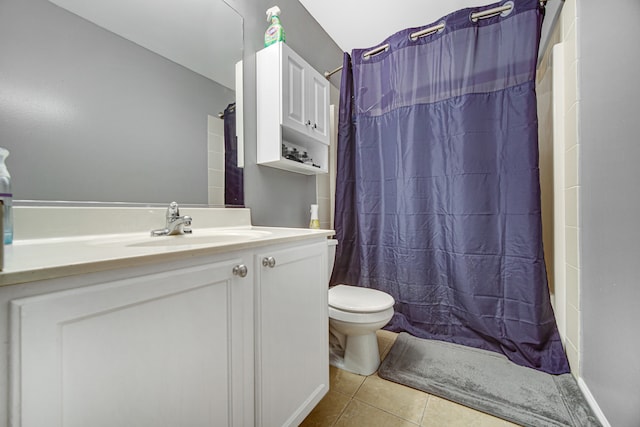 bathroom with curtained shower, vanity, toilet, and tile patterned floors