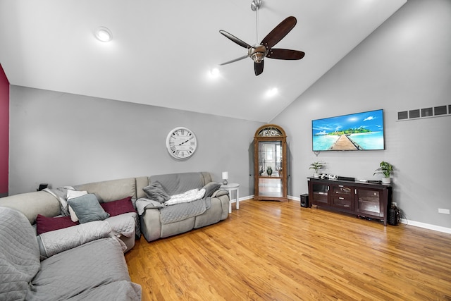 living room with ceiling fan, light hardwood / wood-style flooring, and high vaulted ceiling